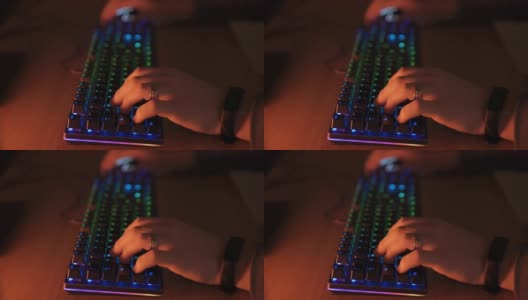 玩家双手敲击电脑键盘，RGB背光照明，专业视频游戏玩家花时间在家里玩虚拟网络游戏。Pro cyber sport gamer概念高清在线视频素材下载
