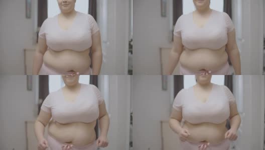 微笑着肚皮上的胖女人跳舞，身体积极，内心自信高清在线视频素材下载