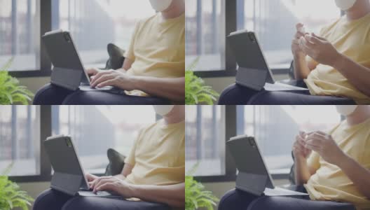 亚洲中年男子戴着眼镜，面罩，在办公空间使用笔记本电脑前喷酒精洗手。预防灰尘和COVID-19。与人保持社交距离。免费的网络高清在线视频素材下载