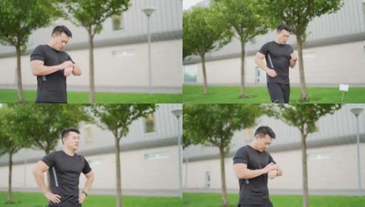 运动亚洲人看智能手表在现代轨道。男子跑步使用智能手表手链。高清在线视频素材下载