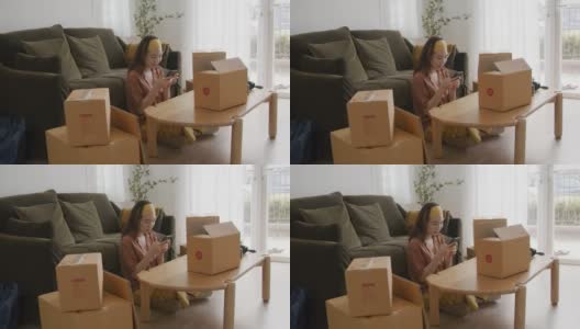 亚洲女人的主人包装纸板箱得到邮包。高清在线视频素材下载