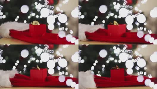 圣诞节投资，比特币在一个以圣诞树和彩灯为背景的礼品盒里高清在线视频素材下载