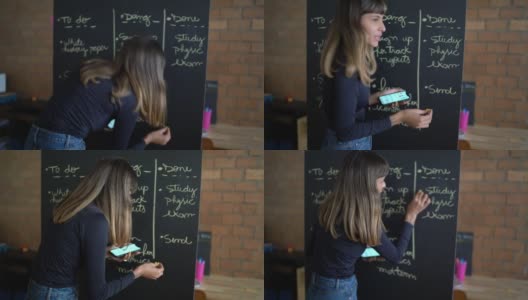 一个正在黑板上写字的年轻女子高清在线视频素材下载