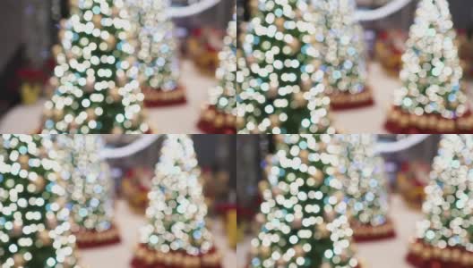 一棵挂着许多灯泡的圣诞树挂在室内。这些是用来做圣诞装饰的。从左向右倾斜射击。的焦点。高清在线视频素材下载