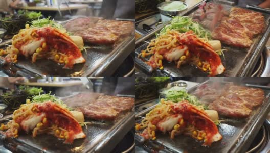 传统的韩国烧烤和配菜蔬菜。烤在大石盘上高清在线视频素材下载