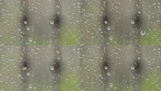 随着风，雨滴落在窗户上的特写图像高清在线视频素材下载