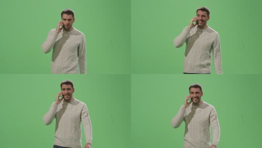 一个随意的白人男子正在一边走一边讲电话，背景是一个绿色的模拟屏幕。高清在线视频素材下载