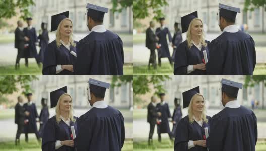 女毕业生戴着方帽拿着毕业证跟同学说话，毕业典礼那天高清在线视频素材下载