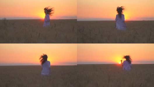 一个漂亮的白人女人在战场上奔跑。这个女孩在尽情地跳舞。大自然母亲。享受日落。地平线上的太阳是金色的。高清在线视频素材下载
