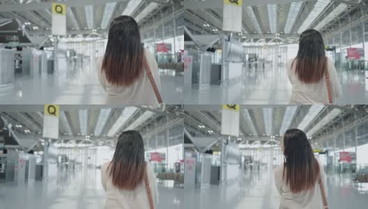 亚洲女旅客在机场，带着行李走过机场办理登机手续，新旅程，旅行假期，跟随后视镜高清在线视频素材下载