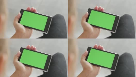 绿色屏幕显示的手机在金发女性的手中高清在线视频素材下载