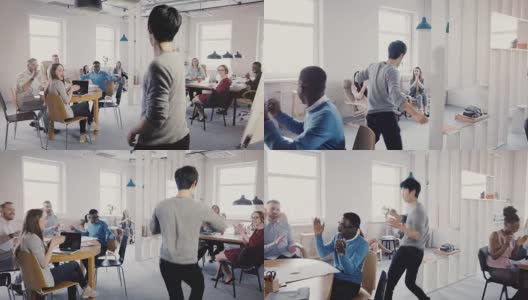 镜头跟随快乐的亚洲人在办公室里跳搞笑的胜利庆祝舞，同事们鼓掌大笑4K高清在线视频素材下载