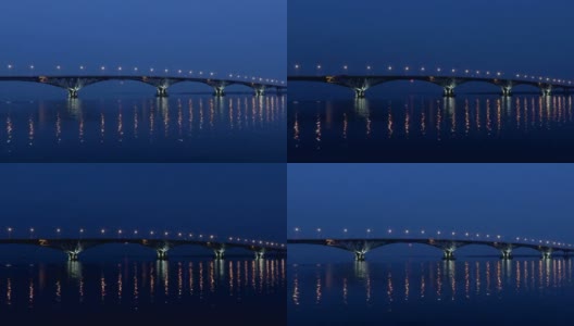 满月从桥上升起。延时。俄罗斯萨拉托夫和恩格斯之间的公路桥。伏尔加河。夜晚的车灯和街灯。4 k,超高清高清在线视频素材下载