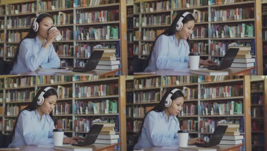 美丽的亚洲女学生听音乐耳机坐在书桌在图书馆工作的学校项目。年轻女孩在笔记本电脑上打字，喝咖啡，在抄写本上写字高清在线视频素材下载