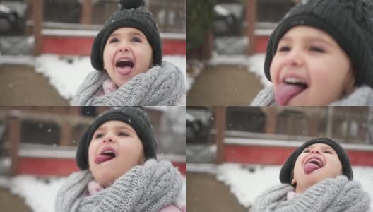 一个年轻女孩用她的舌头捕捉雪花的特写高清在线视频素材下载