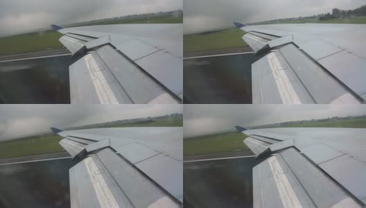 从飞机窗口看机翼起飞雨从左到右高清在线视频素材下载