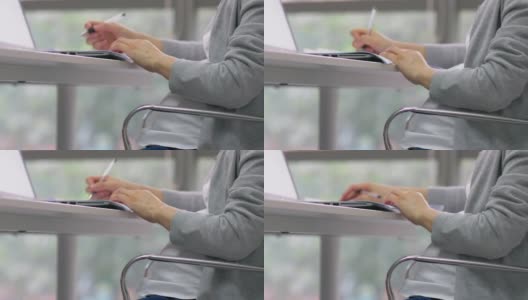 中国怀孕办公室女职员在文件上做笔记高清在线视频素材下载
