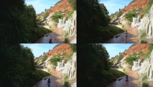 女孩沿着溪边行走在老峡谷鸟瞰图高清在线视频素材下载