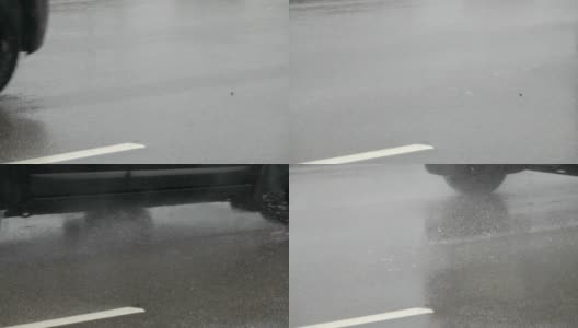 一辆汽车在经过洪水时被溅起。雨天在城市道路上行驶的汽车。缓慢的运动。尖峰时刻的雨。高清在线视频素材下载
