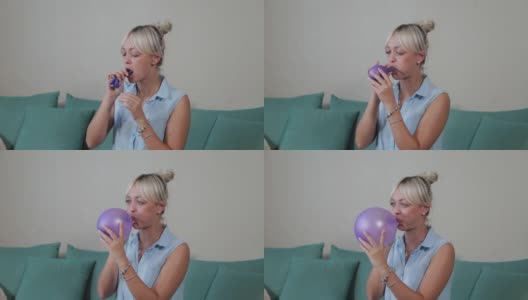 一个女人在公寓里吹彩色气球高清在线视频素材下载