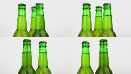 三个绿色啤酒瓶在白色啤酒瓶上旋转高清在线视频素材下载