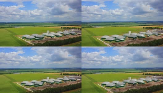 沼气储存罐。绿色田野上的现代有机农场。用于生物质生产的工业装置。鸟瞰图。高清在线视频素材下载