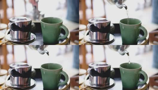 用茶壶将茶倒入绿咖啡杯的慢镜头高清在线视频素材下载