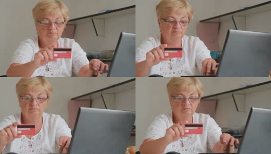 一位上了年纪的妇女在网上输入信用卡数据进行购买高清在线视频素材下载