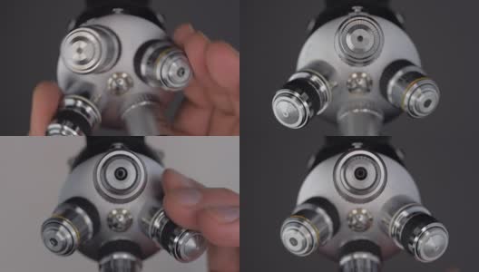 一只手旋转显微镜镜头块，以实现所需的增加高清在线视频素材下载