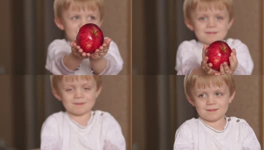 一个手里拿着红苹果的孩子的肖像。高清在线视频素材下载