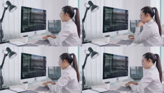 4k视频片段的年轻亚洲女性程序员阅读和工作在电脑上编码开发网站设计和开发技术高清在线视频素材下载