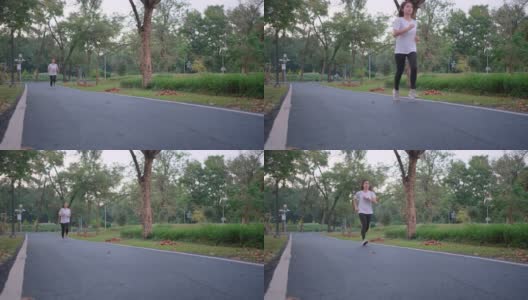 正面的亚洲运动女子是慢跑在道路上的绿色公园与傍晚的光高清在线视频素材下载