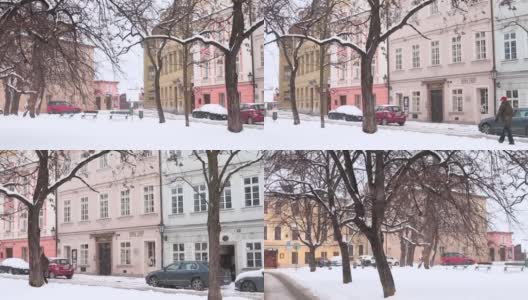 冬天，街上飘着雪花。车停在房子附近。布拉格都市生活。高清在线视频素材下载