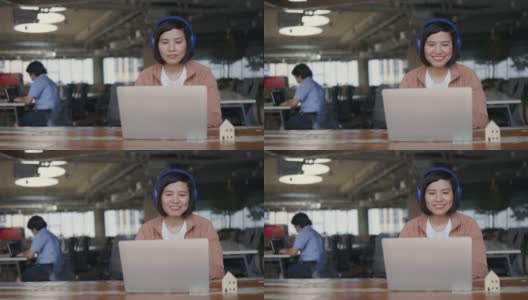 亚洲商务女性戴着耳机坐在共同工作空间的商务咨询会议。营销策划。在网络空间里用免费的Wi-Fi工作。无线技术概念高清在线视频素材下载
