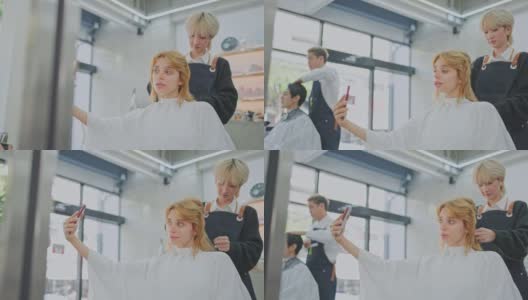 白人美女顾客用手机拍照，自拍，而亚洲专家年轻的发型师或发型师提供服务，检查她的发型在美容院或理发店理发。高清在线视频素材下载