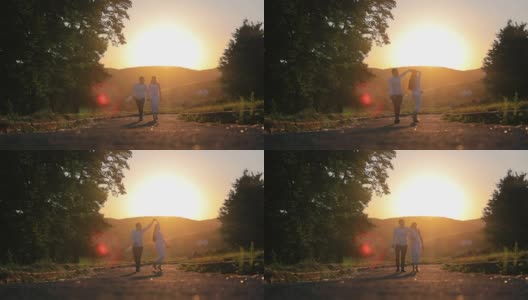 黄昏时分，两个年轻人在公园里散步。夕阳下浪漫的公园里一对对相爱的情侣高清在线视频素材下载