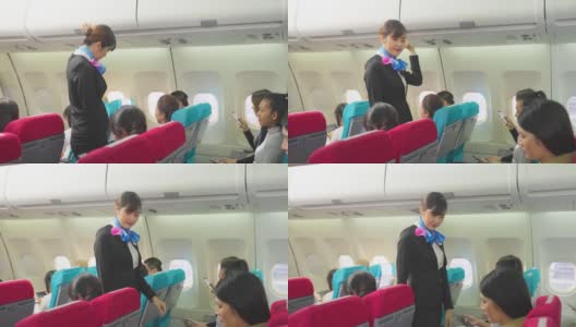 美丽的亚洲空姐或空中小姐在飞机起飞前走在过道上关闭行李舱并检查乘客。飞机客舱机组人员安全检查程序。高清在线视频素材下载