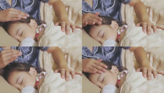 可爱的5岁亚洲女孩，舒适地睡在床上，为可爱的触摸她的母亲，展示了父母和家庭的概念，在晚上快乐和放松。高清在线视频素材下载