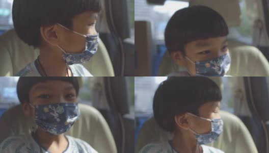 亚洲男孩外出旅行时戴着防护口罩，乘坐汽车出行，以防止冠状病毒。高清在线视频素材下载