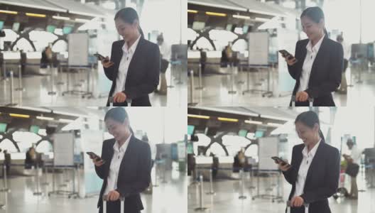女商人在机场使用智能手机高清在线视频素材下载