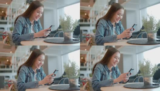 微笑的亚洲女人用智能手机聊天聊天，沟通管理库存。在线申请管理使小企业拓展业务简单方便高清在线视频素材下载