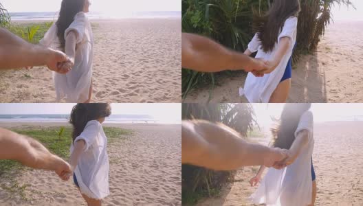 跟着我拍的一个年轻女人拉着她的男朋友在海边。女孩牵着男人的手，在热带异国的海滩上奔向大海。暑假或假期。观点POV慢动作高清在线视频素材下载