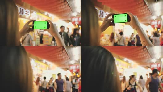 色彩之钥:嬉皮女孩在街上用智能手机拍照。高清在线视频素材下载