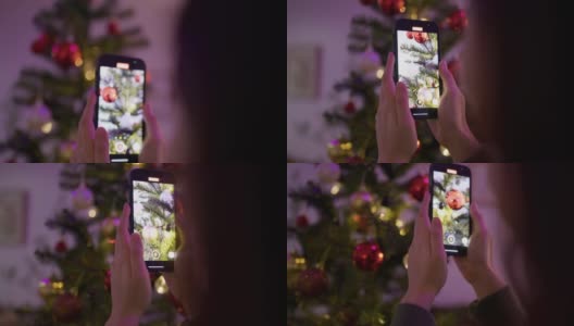 年轻女子在家里与圣诞树合影。高清在线视频素材下载