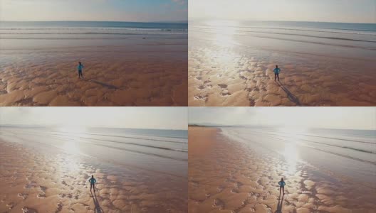 无人机拍摄的运动女子站在岸上的视频高清在线视频素材下载