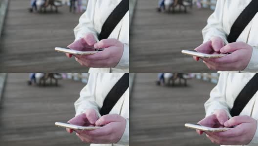 在洛基角公园用智能手机打字的女人高清在线视频素材下载