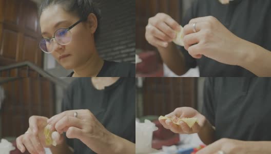 亚洲妇女手工制作馄饨和饺子馅。理念:爱、食物、客人共进晚餐。高清在线视频素材下载