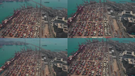 无人机俯视图Pan上方移动的集装箱货船在港口与进出口业务和国际物流航运在城市的货物。吊车在香港维多利亚港的移动速度为4k高清在线视频素材下载