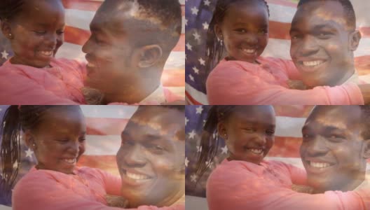 一名身穿军装的军人身后挥舞着美国国旗，他还抱着女儿高清在线视频素材下载