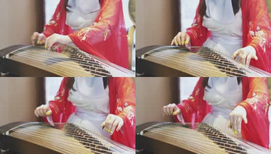 女子弹奏着中国传统乐器，优美动听的古筝高清在线视频素材下载